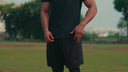 Men's awrah shorts in black showing coverage from navel to knee